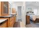 Bathroom with wooden vanity, white tile flooring, and a view into a luxurious primary bedroom suite at 7807 E Main St # Cc-84, Mesa, AZ 85207