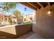 Peaceful outdoor patio area with stylish light fixture and manicured greenery at 8260 E Arabian Trl # 170, Scottsdale, AZ 85258