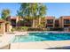 Bright community pool offers a refreshing place to relax with lush landscaping and nearby apartment buildings at 8260 E Arabian Trl # 170, Scottsdale, AZ 85258