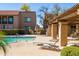 Relaxing pool area features several lounge chairs and patio seating, with pool access steps for ease of entry at 8260 E Arabian Trl # 170, Scottsdale, AZ 85258