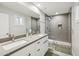 Modern bathroom with dual sinks and a sleek glass-enclosed shower at 8307 E Montebello Ave, Scottsdale, AZ 85250