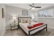 Bright bedroom featuring a queen-size bed, ceiling fan, and natural light from the window with shutters at 8307 E Montebello Ave, Scottsdale, AZ 85250