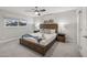 Bright bedroom featuring a king-size bed, ceiling fan, and natural light from the window at 8307 E Montebello Ave, Scottsdale, AZ 85250