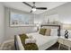 Bedroom showcasing a comfy queen-size bed, ceiling fan, and bright window with white shutters at 8307 E Montebello Ave, Scottsdale, AZ 85250