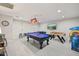 Spacious game room with a pool table, foosball, and fun lighting at 8307 E Montebello Ave, Scottsdale, AZ 85250