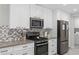 Well-equipped kitchen with stainless steel appliances and subway tile backsplash at 8307 E Montebello Ave, Scottsdale, AZ 85250