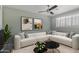 Bright living room features a modern white sectional sofa, abstract art, and contemporary coffee tables at 8307 E Montebello Ave, Scottsdale, AZ 85250