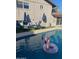 Backyard pool with lounge chairs and a pink flamingo float at 8307 E Montebello Ave, Scottsdale, AZ 85250