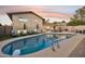 Relaxing backyard pool with lounge chairs and covered patio, perfect for outdoor entertaining at 8307 E Montebello Ave, Scottsdale, AZ 85250