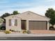 Charming single-story home with a two-car garage, neutral color palette, and beautiful desert landscaping at 8669 W Warner St, Tolleson, AZ 85353