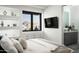 Bright bedroom featuring built in drawer storage and shelving with mountain views through a modern black framed window at 8822 E Chino Dr, Scottsdale, AZ 85255