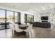 Dining area with large windows, a modern table, and seating for eight guests at 8822 E Chino Dr, Scottsdale, AZ 85255