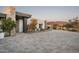 Elegant driveway with stone accents and desert plants leading to a modern home at 8822 E Chino Dr, Scottsdale, AZ 85255