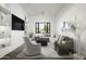 Comfortable living room featuring a large sectional sofa, gray armchair, and modern decor elements at 8822 E Chino Dr, Scottsdale, AZ 85255