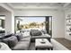 The living room features a gray sectional and sliding doors to the outdoor patio at 8822 E Chino Dr, Scottsdale, AZ 85255