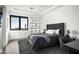 Well-lit main bedroom featuring sleek built-ins, a stylish accent wall, and a comfortable queen-sized bed at 8822 E Chino Dr, Scottsdale, AZ 85255