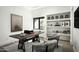 Well-lit home office featuring a large desk, decorative shelving, and stylish seating with a neutral rug at 8822 E Chino Dr, Scottsdale, AZ 85255