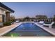 Night view of a sparkling pool with water features and elegant lighting, creating an inviting ambiance at 8822 E Chino Dr, Scottsdale, AZ 85255