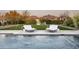 Poolside view featuring cascading water features, lounge chairs, and manicured landscaping at 8822 E Chino Dr, Scottsdale, AZ 85255