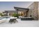 Luxurious backyard pool area with modern patio furniture, fountains and a stacked stone accent wall at 8822 E Chino Dr, Scottsdale, AZ 85255