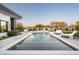 Luxurious pool with built-in water features and lounge chairs offers a serene outdoor retreat at 8822 E Chino Dr, Scottsdale, AZ 85255