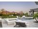 Backyard pool and jacuzzi surrounded by lush landscaping, mountains in the background, and ample seating at 8822 E Chino Dr, Scottsdale, AZ 85255