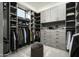 Well-organized walk-in closet with gray cabinets, shelving and drawers provides abundant storage space at 8822 E Chino Dr, Scottsdale, AZ 85255