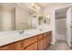 Bathroom featuring dual sinks, granite countertops, and a large vanity mirror at 9151 W Greenway Rd # 277, Peoria, AZ 85381