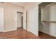 Bedroom featuring wood floors, closet, and an open entryway to a hallway at 9151 W Greenway Rd # 277, Peoria, AZ 85381