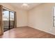 Bedroom featuring wood floors, a sliding glass door to a private balcony, and a window at 9151 W Greenway Rd # 277, Peoria, AZ 85381