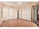 This bedroom includes a ceiling fan, a sliding glass door to the patio, and dual door closets at 9151 W Greenway Rd # 277, Peoria, AZ 85381