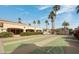 Community shuffleboard court for residents' enjoyment, set amidst lush greenery and towering palms at 9151 W Greenway Rd # 277, Peoria, AZ 85381