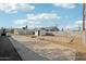 Wide angle view of backyard concrete slab, utility shed, and block wall fence at 9156 W Garfield St, Tolleson, AZ 85353