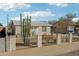 Single-story home with low maintenance landscaping, fenced front yard, and well-lit entryway at 9156 W Garfield St, Tolleson, AZ 85353