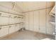 Garage with shelves, ample storage space, and painted walls at 9156 W Garfield St, Tolleson, AZ 85353