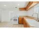 This bright kitchen includes ample cabinetry, a tile floor, and modern appliances at 9156 W Garfield St, Tolleson, AZ 85353