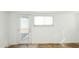 An unfurnished, light room with two windows and a glass door at 9156 W Garfield St, Tolleson, AZ 85353