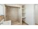 Tiled shower with updated showerhead and open shelving at 9156 W Garfield St, Tolleson, AZ 85353