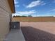 Backyard featuring air conditioning unit, rock landscaping, and fence at 970 W Diamond Rim Dr, Casa Grande, AZ 85122