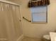 Cozy bathroom featuring a shower with curtain, tiled floor, and window at 970 W Diamond Rim Dr, Casa Grande, AZ 85122