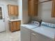 Spacious laundry room with washer, dryer, cabinets, and wash basin at 970 W Diamond Rim Dr, Casa Grande, AZ 85122