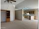 Open living area flowing into the kitchen with neutral carpet and a display case at 970 W Diamond Rim Dr, Casa Grande, AZ 85122