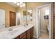 Bathroom featuring a large vanity with dual sinks, tile flooring and a connecting door to the toilet at 9765 E Lompoc Ave, Mesa, AZ 85209