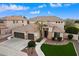 Stunning two-story home featuring a three-car garage and beautifully landscaped front yard at 9765 E Lompoc Ave, Mesa, AZ 85209