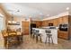 Inviting kitchen with wooden cabinets, breakfast bar, black appliances, and adjacent dining area at 9765 E Lompoc Ave, Mesa, AZ 85209