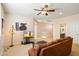 Spacious living room featuring a comfortable brown sofa and a staircase, perfect for relaxation at 9765 E Lompoc Ave, Mesa, AZ 85209