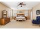 Main bedroom featuring neutral walls, carpet flooring, a ceiling fan and a comfortable king bed at 9765 E Lompoc Ave, Mesa, AZ 85209