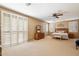 Expansive main bedroom with a ceiling fan, neutral walls, carpet flooring, and plantation shutters at 9765 E Lompoc Ave, Mesa, AZ 85209