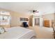 Large main bedroom with a ceiling fan, neutral walls, carpet flooring and an ensuite bathroom at 9765 E Lompoc Ave, Mesa, AZ 85209