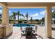 Inviting outdoor patio with a dining table and comfortable seating, perfect for enjoying the pool view at 9765 E Lompoc Ave, Mesa, AZ 85209